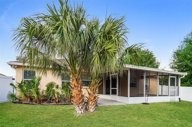 a view of a house with a yard and plants