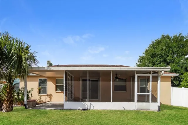 a view of a house with a yard and potted plants