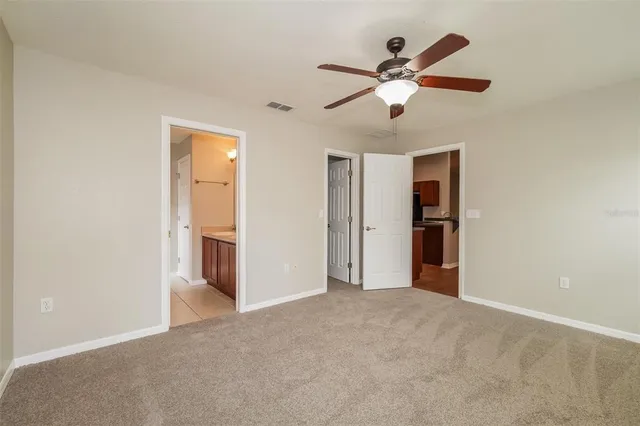a view of an empty room with a ceiling fan