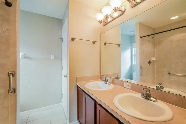 a bathroom with a double vanity sink and a mirror