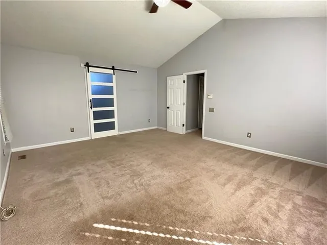 an empty room with windows and entrance