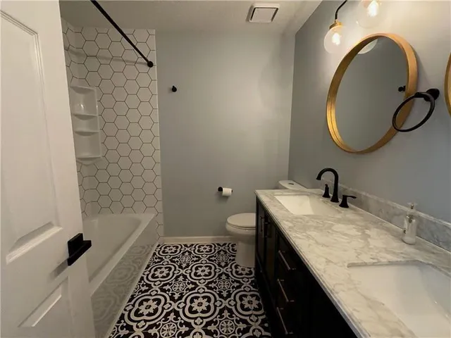 an empty room with a ceiling fan and window