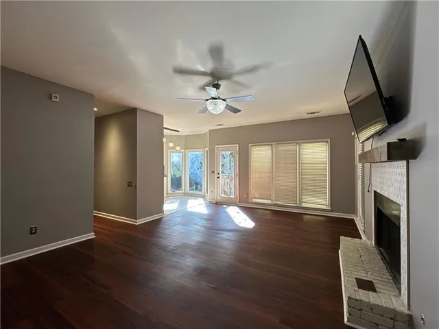 a view of a livingroom with a furniture wooden floor and a ceiling fan