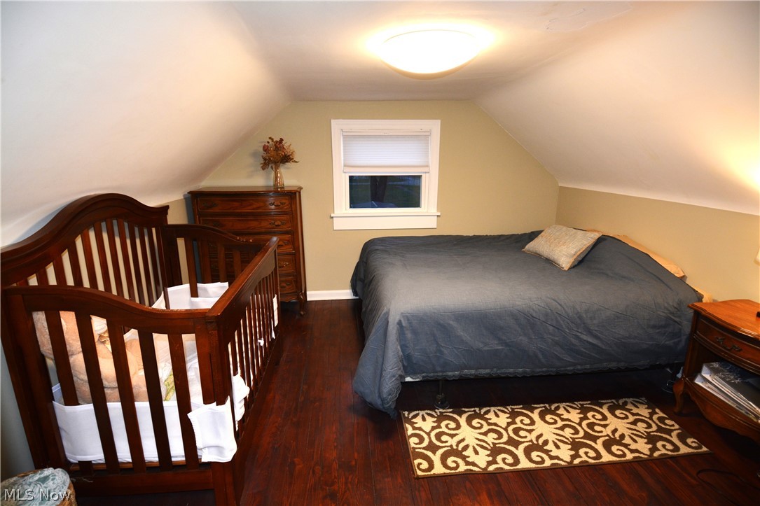 67 Medina Street Rittman, OH 44270 - Photo 16 of 26 Bedroom with dark hardwood / wood-style floors and lofted ceiling
