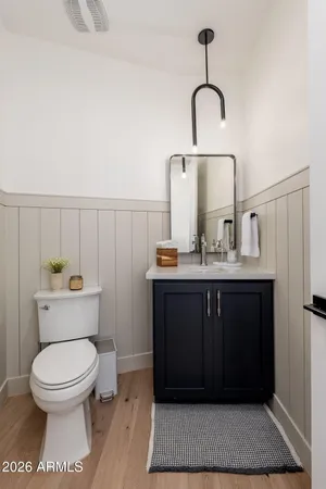 a bathroom with a toilet a sink and mirror