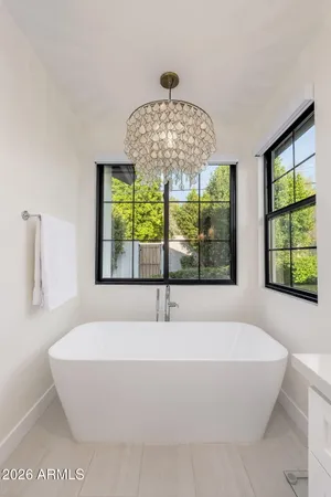 a white bath tub sitting in a bathroom next to a window
