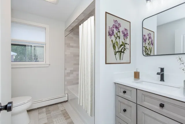 a bathroom with a toilet a sink and glass door