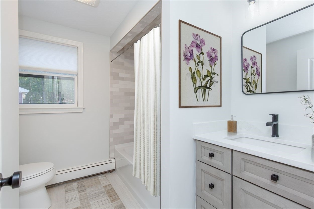 2 Oceanview Avenue Saugus, MA 01906 - Photo 16 of 41 a bathroom with a toilet a sink and glass door