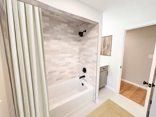 a bathroom with a tub and shower