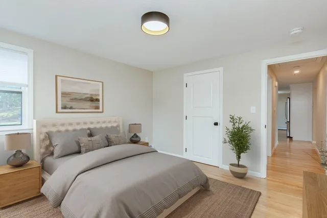 a bedroom with a balcony and a potted plant