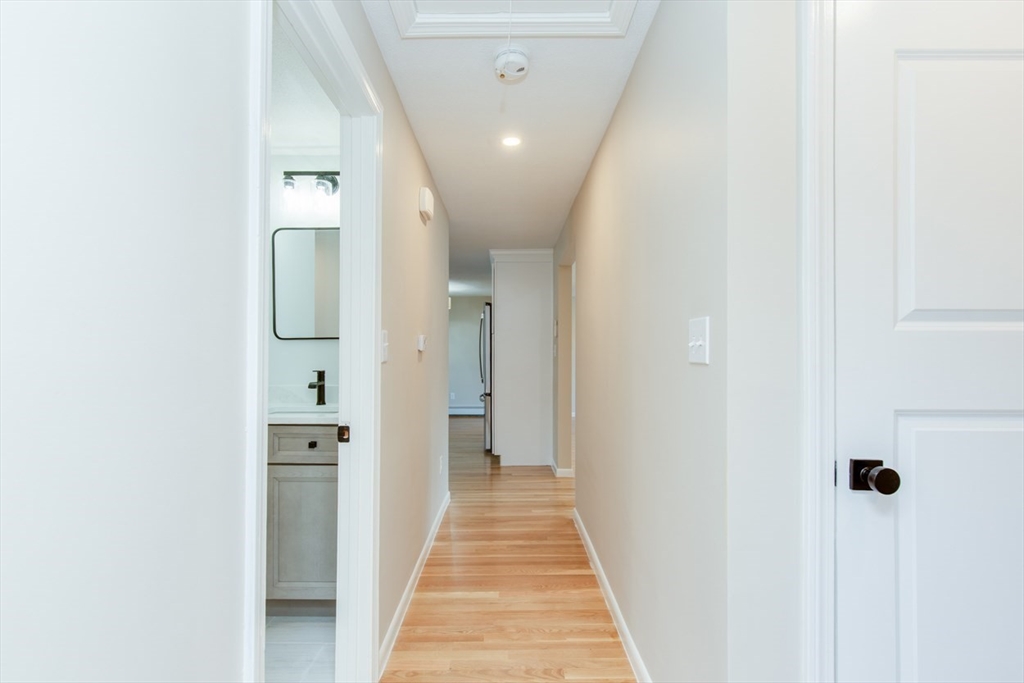2 Oceanview Avenue Saugus, MA 01906 - Photo 33 of 41 a view of a hallway with wooden floor and a bathroom