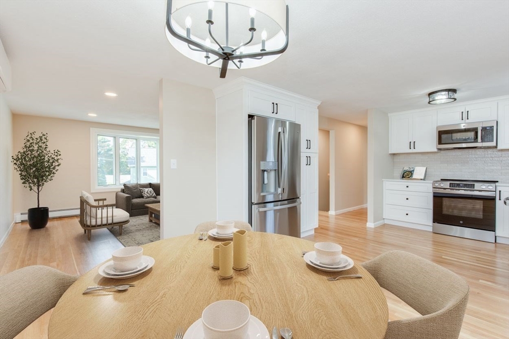 2 Oceanview Avenue Saugus, MA 01906 - Photo 9 of 41 a kitchen with stainless steel appliances kitchen island granite countertop a table and chairs in it