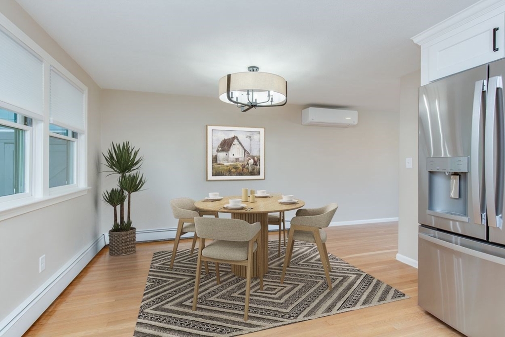2 Oceanview Avenue Saugus, MA 01906 - Photo 10 of 41 a dining room with wooden floor a chandelier a wooden table and chairs