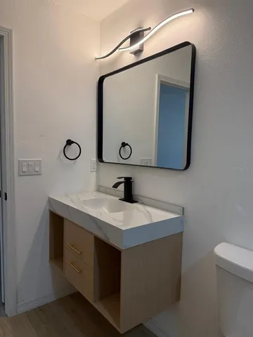 a bathroom with a sink a vanity and a mirror
