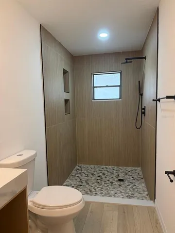a bathroom with a shower and a toilet