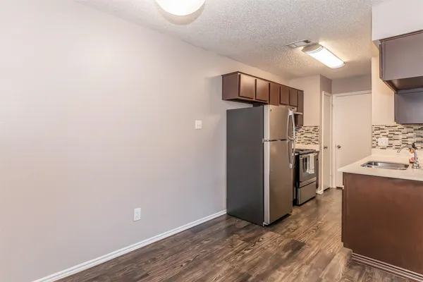 a kitchen with wooden cabinets and a stove top oven