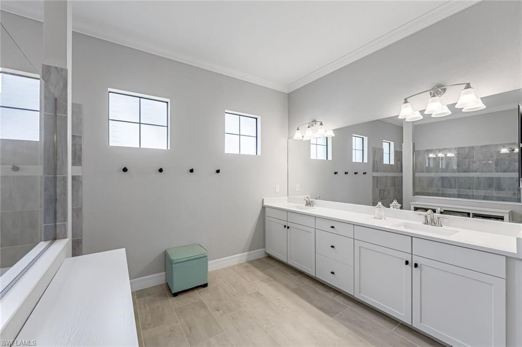 19437 The Pl Boulevard Estero, FL 33928 - Photo 15 of 37 a bathroom with a double vanity sink and a mirror