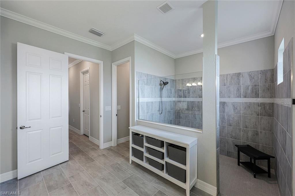 19437 The Pl Boulevard Estero, FL 33928 - Photo 16 of 37 a bathroom with a shower and a sink