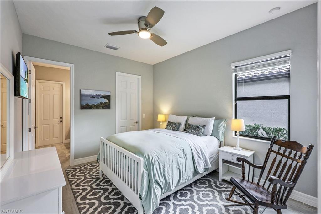 19437 The Pl Boulevard Estero, FL 33928 - Photo 17 of 37 a bedroom with a bed and a chandelier