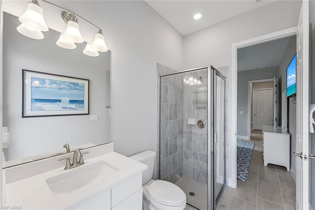 19437 The Pl Boulevard Estero, FL 33928 - Photo 18 of 37 a bathroom with a toilet sink and shower