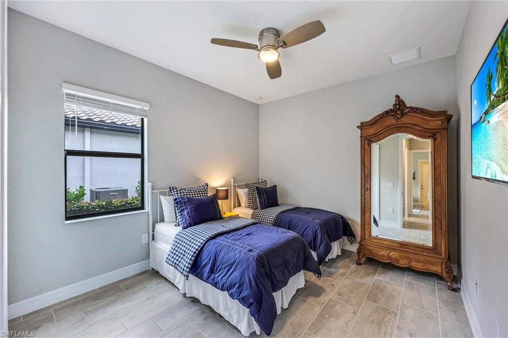 19437 The Pl Boulevard Estero, FL 33928 - Photo 19 of 37 a spacious bedroom with a bed and a window