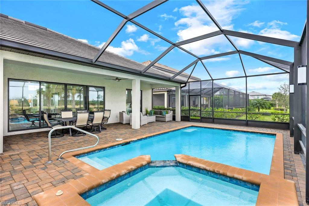 19437 The Pl Boulevard Estero, FL 33928 - Photo 23 of 37 a view of a swimming pool with chairs in patio