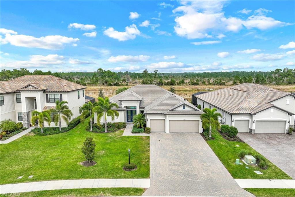 19437 The Pl Boulevard Estero, FL 33928 - Photo 28 of 37 a view of houses with yard and outdoor seating