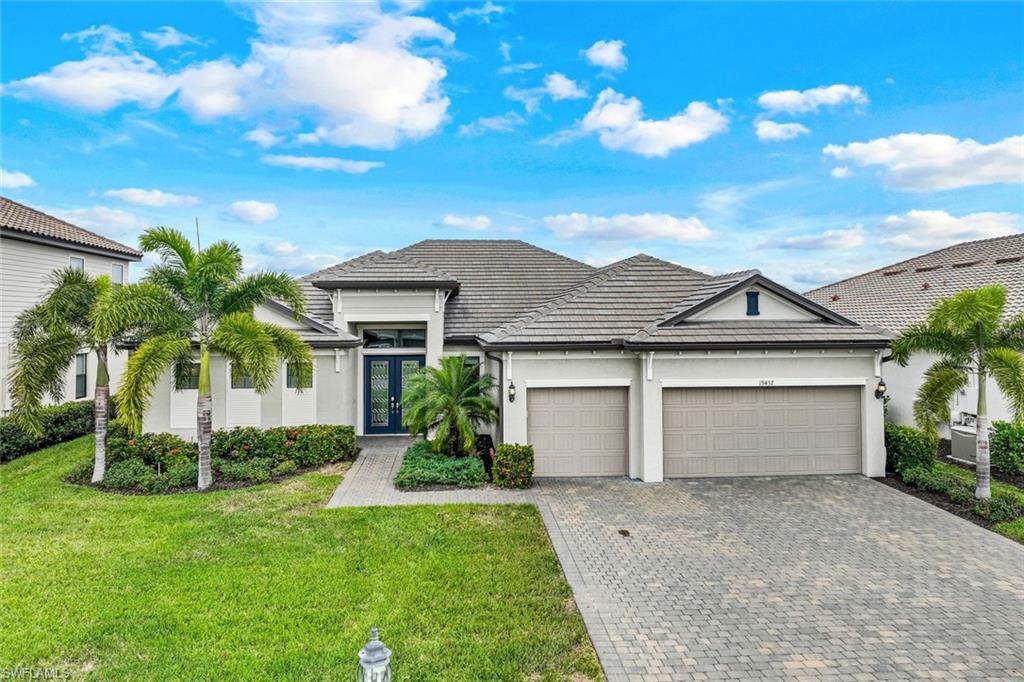 19437 The Pl Boulevard Estero, FL 33928 - Photo 29 of 37 a front view of a house with a garden