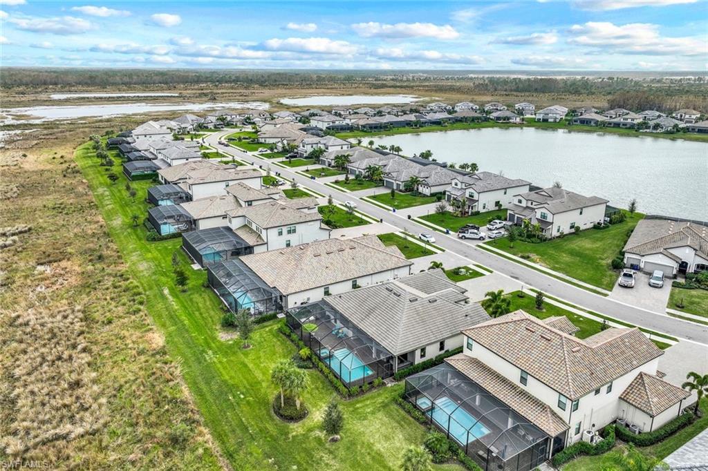 19437 The Pl Boulevard Estero, FL 33928 - Photo 31 of 37 an aerial view of a house with a garden and lake view