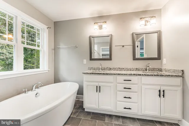 a bathroom with a granite countertop sink mirror and
