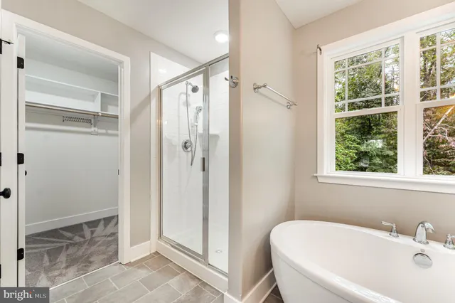 a bathroom with a tub shower and a sink