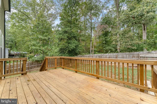 a view of balcony with wooden floor and fence