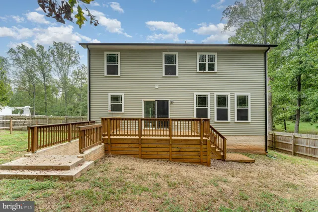 a view of house with backyard