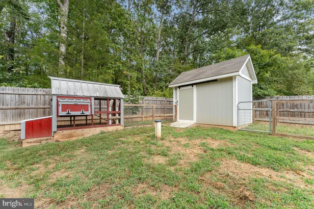 a backyard of a house with oven and swing