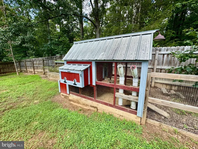 a view of backyard with deck and outdoor seating
