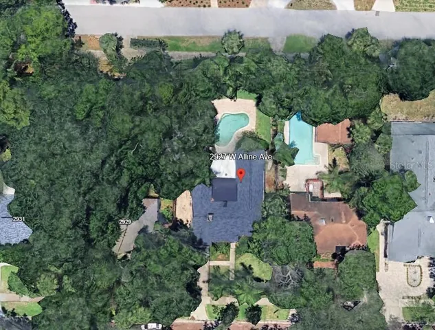 an aerial view of a house with a yard and outdoor seating