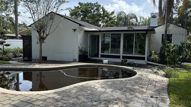 a view of a swimming pool with a yard