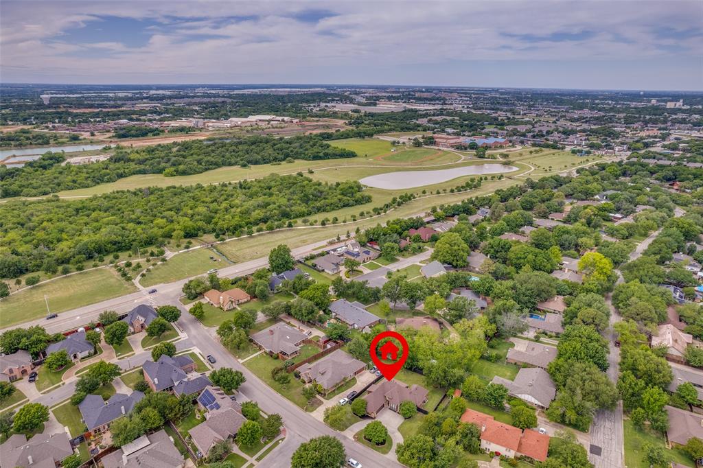 809 Longridge Drive Denton, TX 76205 - Photo 5 of 31 Aerial perspective highlighting a residential neighborhood with mature trees, green spaces, and a nearby body of water