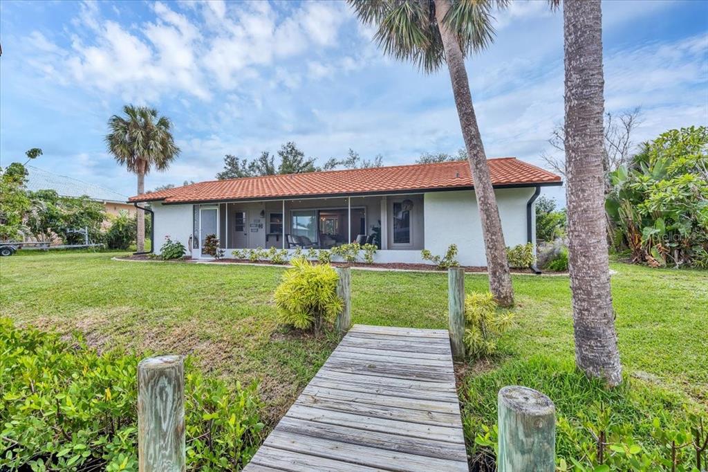 4696 Pompano Street Placida, FL 33946 - Photo 21 of 23 a front view of a house with a yard