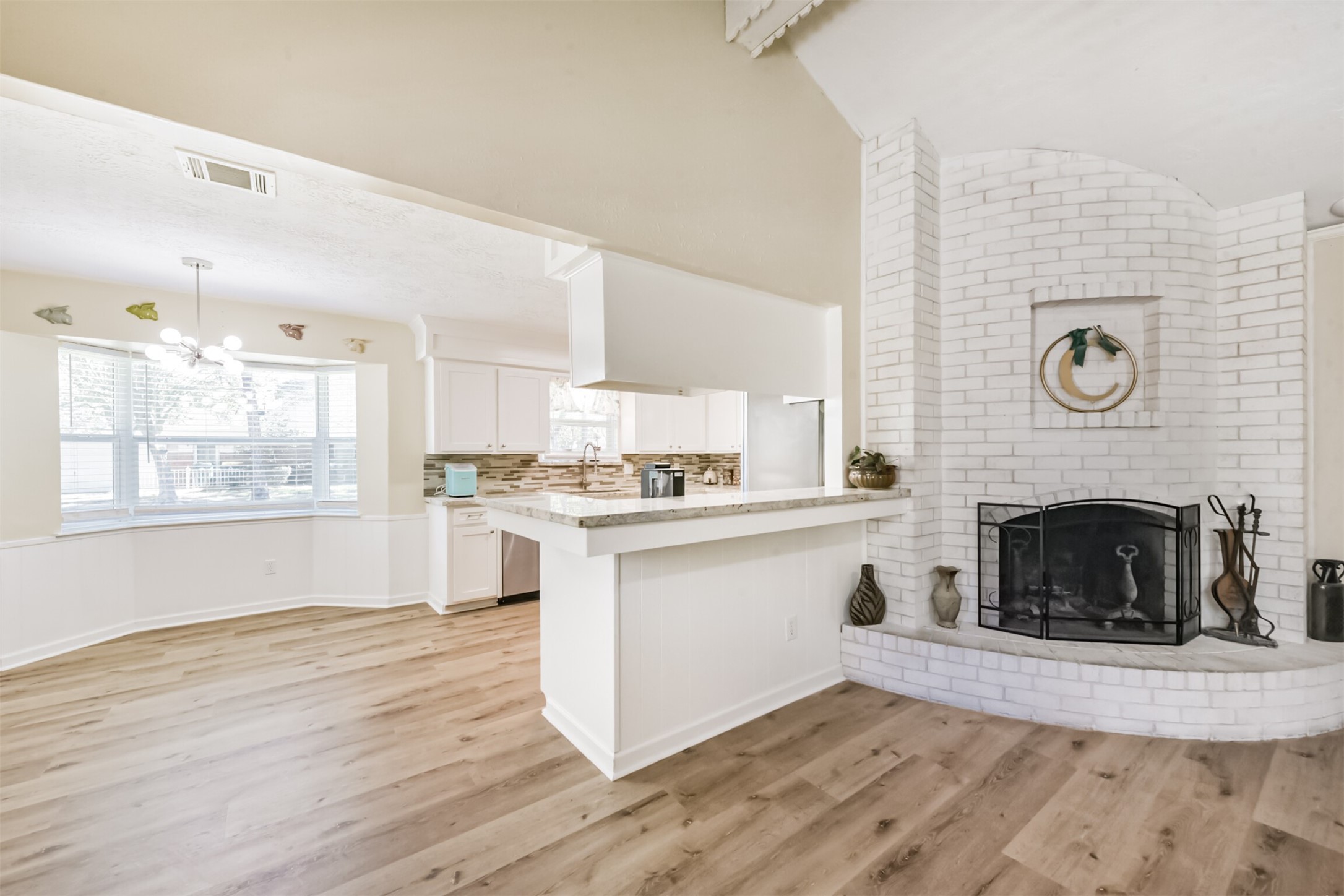 2011 North Palm Court Pasadena, TX 77502 - Photo 11 of 39 a living room with stainless steel appliances wooden floor and a fireplace