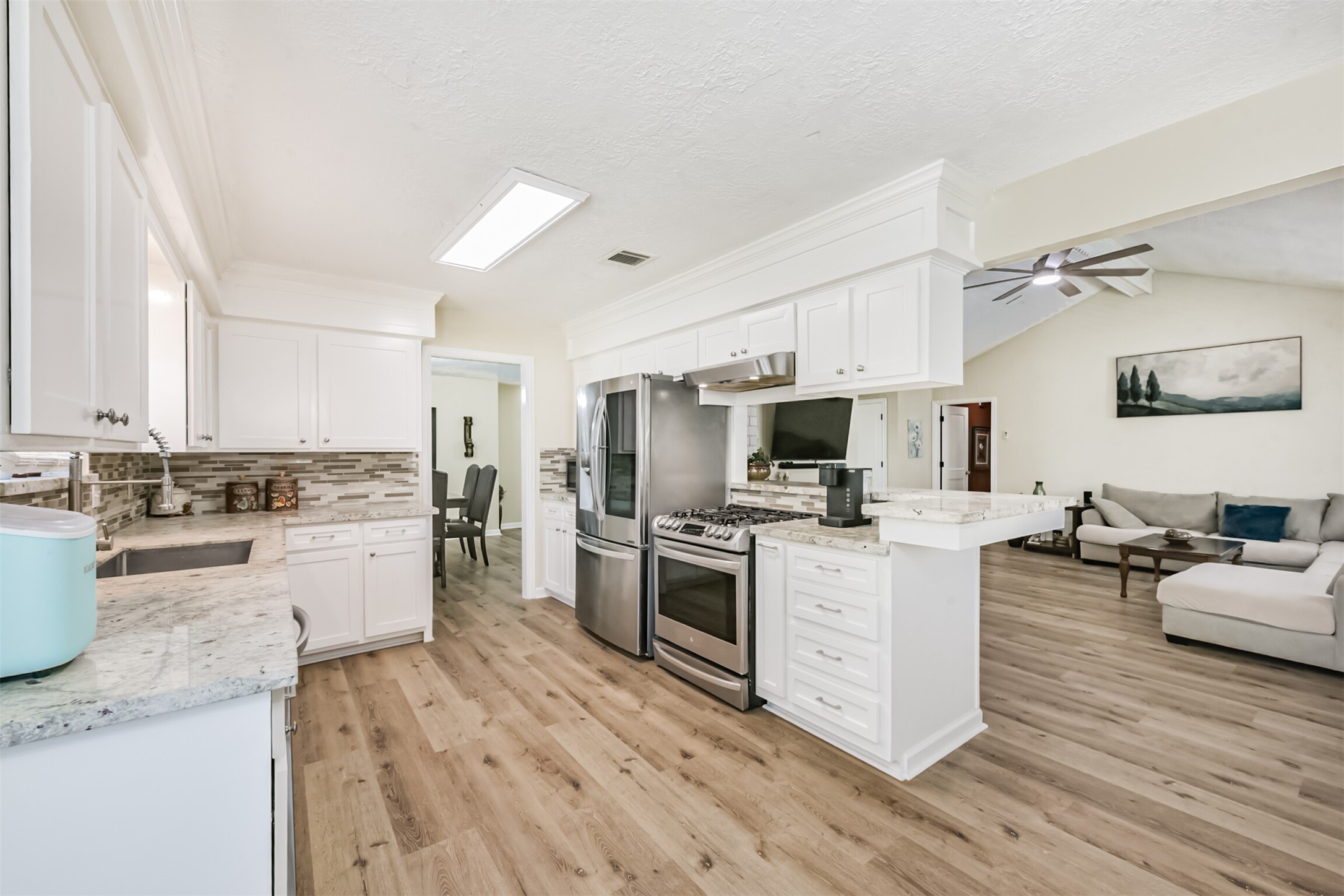 2011 North Palm Court Pasadena, TX 77502 - Photo 13 of 39 a large kitchen with a lot of counter space and wooden floor