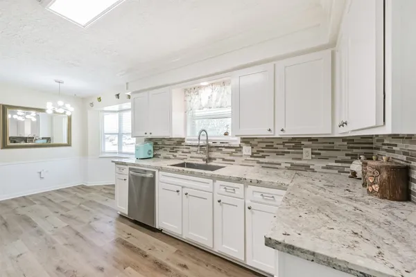 a kitchen with a sink stove and cabinets