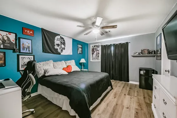 a bedroom with bed and a large mirror