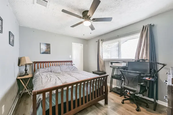 a bedroom with a bed and a ceiling fan