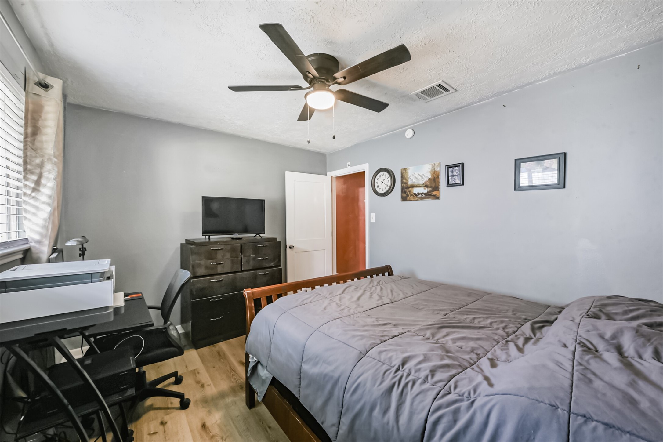 2011 North Palm Court Pasadena, TX 77502 - Photo 22 of 39 a bedroom with a bed and a ceiling fan