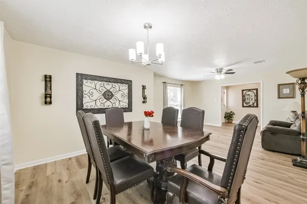 a dining room with furniture and window