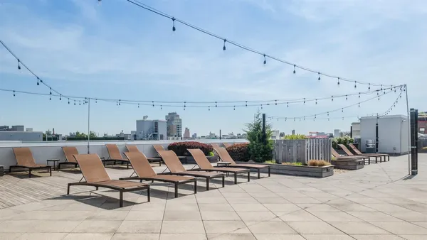 a view of a terrace with furniture and lounge chairs