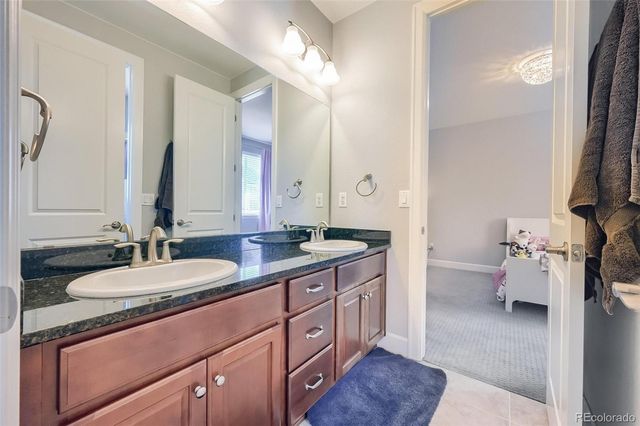 a spacious bathroom with a double vanity sink and a mirror