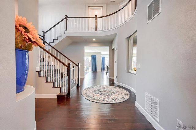 a view of an entryway with wooden floor