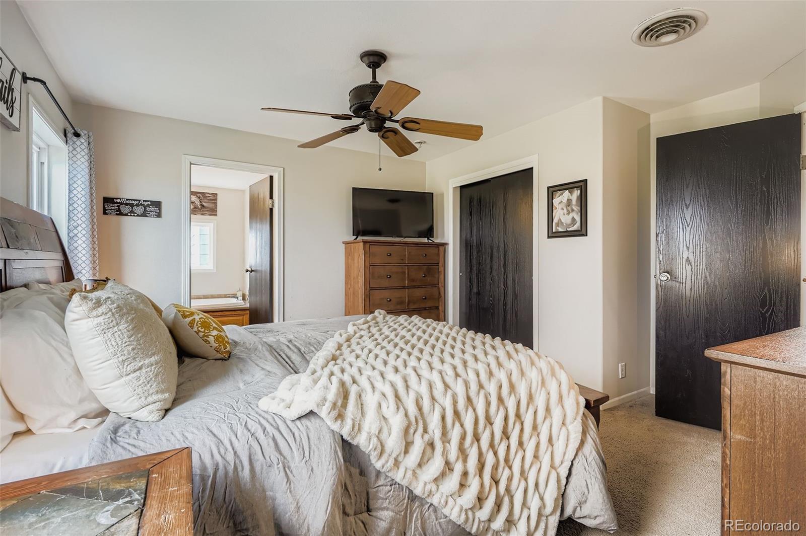 26540 Flower Circle Simla, CO 80835 - Photo 19 of 40 a bedroom with a bed and a chandelier